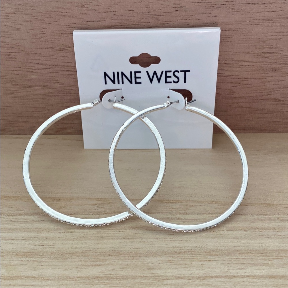 Nine West Elegant 2 1/4” Silver tone Hoop Earrings with Crystal detail.